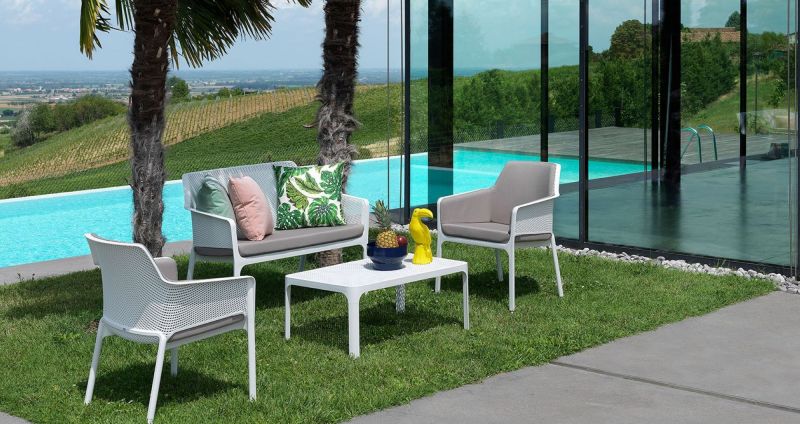 Table basse en polypropylène accompagnée de fauteuils et du canapé collection Net par Nardi à Lyon